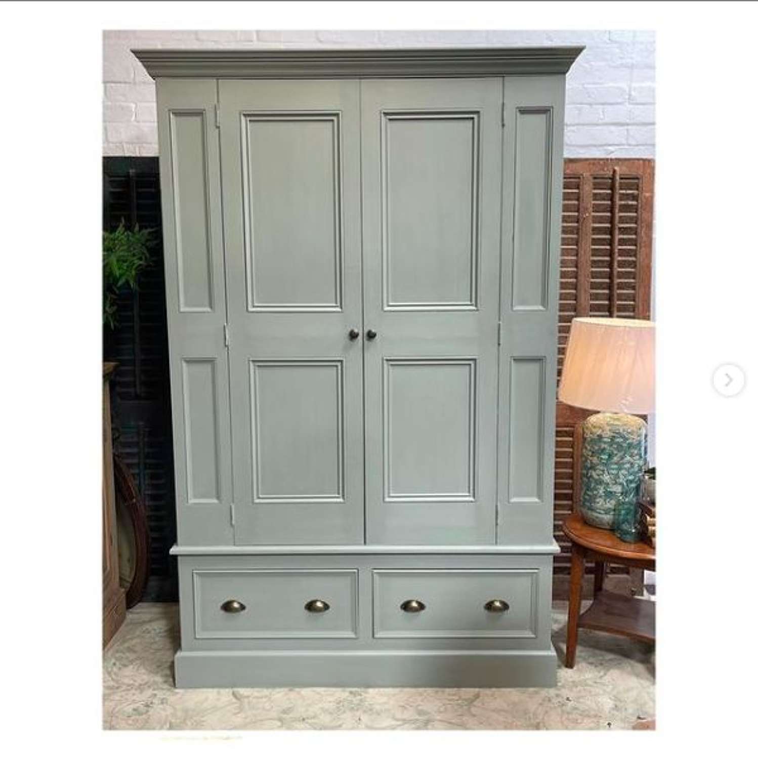 Regency style panelled wardrobe with drawers below.